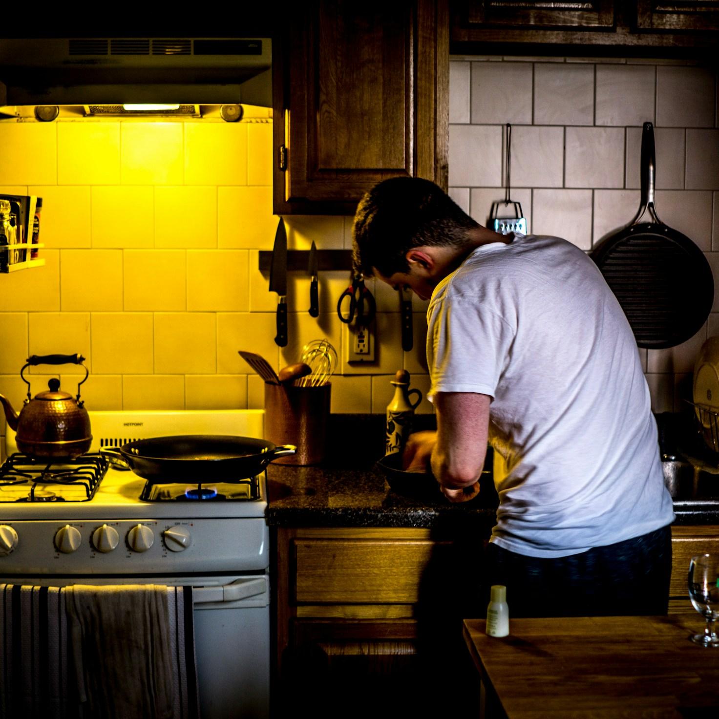 Community members collaborating in a modern kitchen space, sharing recipes and cooking techniques